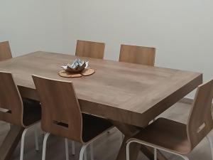 a wooden table with chairs and a bowl of flowers on it at Meri per sempre in Pontebba +24 photos