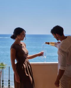 a man pouring a woman a glass of wine at Hotel IPV Palace & Spa - Adults Recommended in Fuengirola