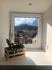 a window in a white room with a view of a mountain at Dimora Concordia in Calavino