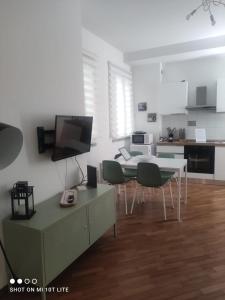 a living room with a table and chairs and a kitchen at amaRE in Reggio Emilia