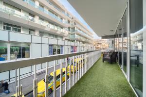 a corridor of a building with yellow taxis at Funchal Paradise in Funchal