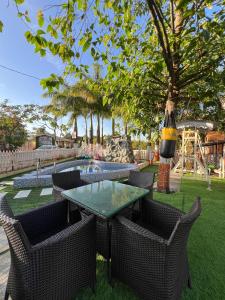 a table and chairs in a yard with a playground at Green Paradise - Trimbakeshwar in Trimbak