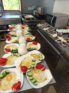 a bunch of plates of food on a counter in a kitchen at Villa Goliku in Peshtan +43 photos