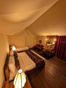 a bedroom with a bed in a tent at Gaga Bees Udawalawe in Udawalawe