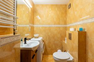 a small bathroom with a toilet and a sink at Reda Cozy Nest Apartment by BookingHost in Reda +21 photos
