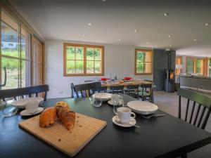 a table with two loaves of bread on top of it at Chalet Morris - OVO Network in Sixt +22 photos