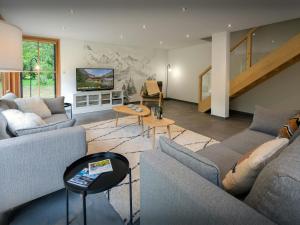 a living room with two couches and a tv at Chalet Morris - OVO Network in Sixt