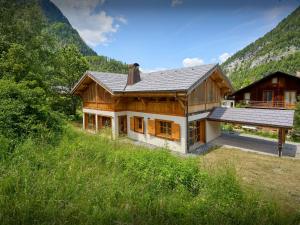 a large wooden house in the middle of a field at Chalet Morris - OVO Network in Sixt