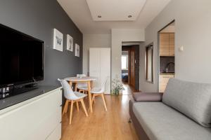 a living room with a couch and a table at Reda Cozy Nest Apartment by BookingHost in Reda