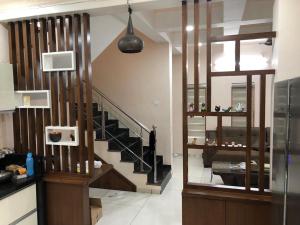 a living room with a staircase and a living room at Vadodara Homestay in Vadodara