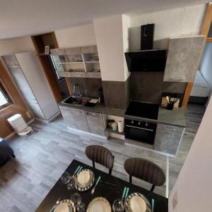 an overhead view of a kitchen with a table and chairs at Ruheoase im Südschwarzwald in Albbruck +22 photos