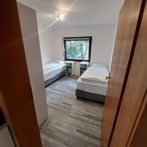 a bedroom with two beds and a window at Ruheoase im Südschwarzwald in Albbruck