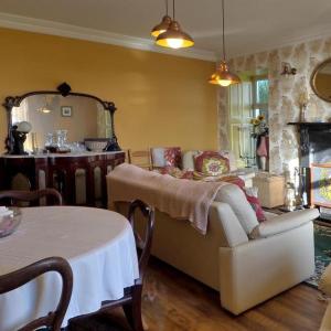a living room with a couch and a table at Shannonview Country House in Labasheeda