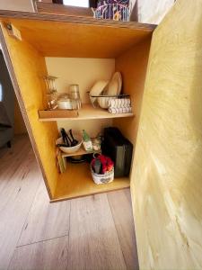 a wooden shelf with dishes and other items in a room at Glampeak Adamov in Adamov +5 photos