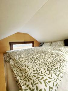 a bedroom with a bed with a white comforter at Glampeak Adamov in Adamov