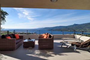a balcony with chairs and a view of the ocean at Résidence Aria Marina in Propriano
