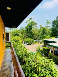 a balcony with a television on the side of a building at Resolve Garden Hotel in Dodangoda
