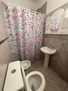 a bathroom with a toilet and a sink at Solares de Sabatini in Villa del Totoral