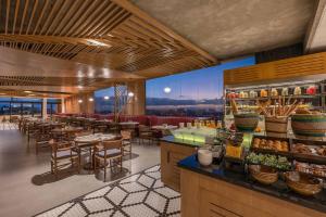 a restaurant with tables and chairs and a bar at Hyatt Regency Nairobi Westlands in Nairobi