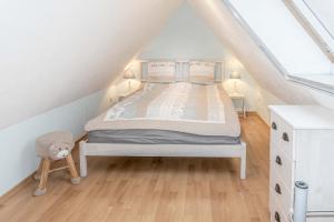 a bedroom with a bed in a attic at Ferienhaus Ostsee in Pruchten