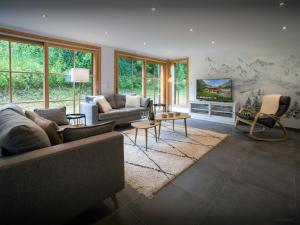 a living room with two couches and a tv at Chalet Morris - OVO Network in Sixt