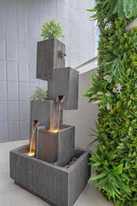 a water fountain in a bathroom with a plant at Waterfront 3bed | Pool | 10min walk to Beach in Hallandale Beach