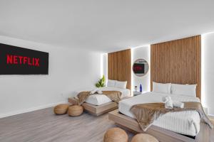 a bedroom with two beds and a netflix sign on the wall at Waterfront 3bed | Pool | 10min walk to Beach in Hallandale Beach