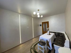 a room with a table and a table and chairs at У Оксани in Solochyn