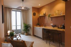 a kitchen with a counter and chairs in a room at Camillò Guest House in Ivrea