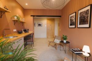 a kitchen and living room with a counter and chairs at Camillò Guest House in Ivrea +18 photos