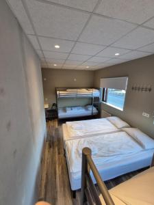 a bedroom with two beds in a room at Við Hafið Oceanfront Guesthouse in Ólafsvík +60 photos