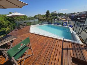 a deck with a swimming pool on top of a building at Bagu Siete Bocas in Puerto Iguazú