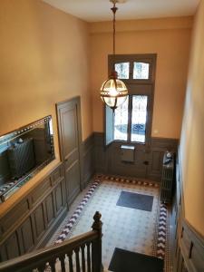 an empty hallway with a staircase and a window at La Tour Jayan in Agen