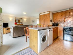 a kitchen with a washer and a living room at 1 Bed in Helston oc-bbird in Saint Martin