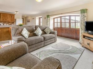 a living room with a couch and a tv at 1 Bed in Helston oc-bbird in Saint Martin