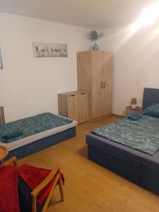 a room with two beds and wooden cabinets at Rekreační chata Kocába in Štěchovice