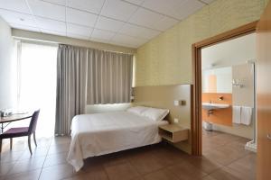 Letto o letti in una camera di Tatì Hotel