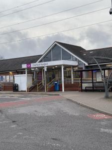 a building with a bus stop in front of it at Haven at Chafford Hundred in West Thurrock