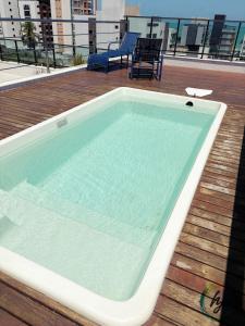 a swimming pool on the deck of a building at Vista Mare 402 in Ilha da Restinga