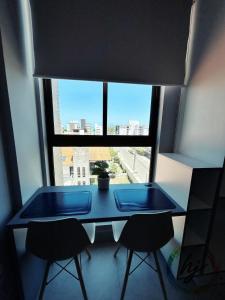 a blue table in a room with a large window at Vista Mare 402 in Ilha da Restinga