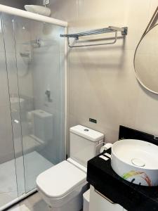 a bathroom with a shower and a toilet and a sink at Vista Mare 402 in Ilha da Restinga