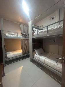 a room with two bunk beds in it at Sleep Squad Hostel in El Nido