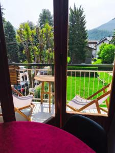 a view of a balcony with a table and chairs at Central near station in Bardonecchia +6 photos