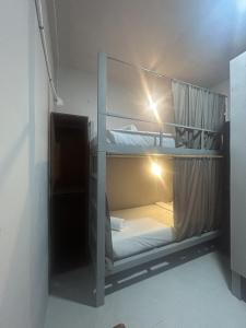 a room with two bunk beds in a room at Sleep Squad Hostel in El Nido