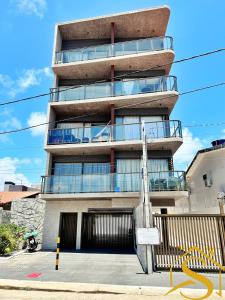 a tall building with a balcony on the side of it at Ble Camboinha 101 in Camalaú