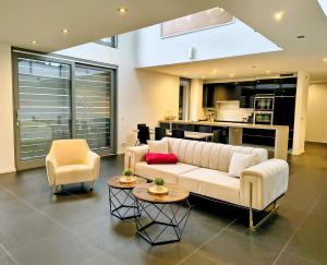 a living room with a white couch and two chairs at Villa in Meisenheim