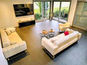 a living room with two couches and two chairs at Villa in Meisenheim