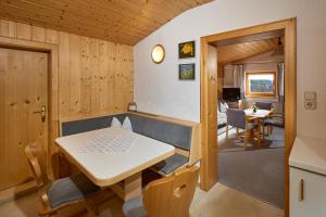 a dining room and living room with a table and chairs at Haus Muster - Hochmontafon in Partenen