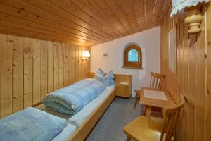 a bedroom with a bed and a desk and a chair at Haus Muster - Hochmontafon in Partenen