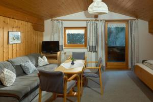a living room with a couch and a table at Haus Muster - Hochmontafon in Partenen